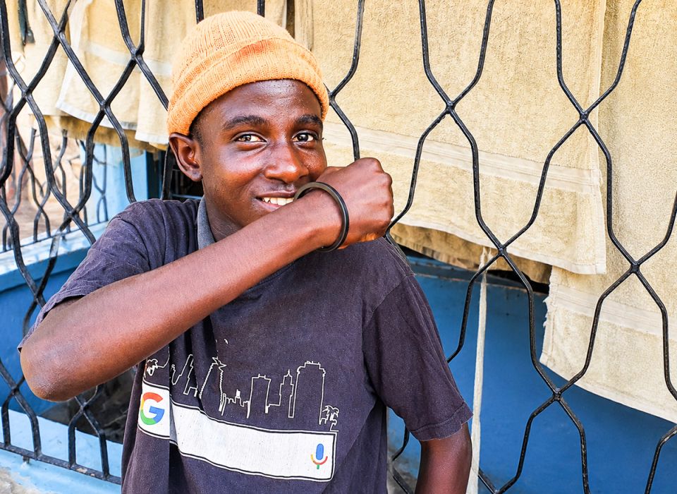 Simon, young man smiles at camera