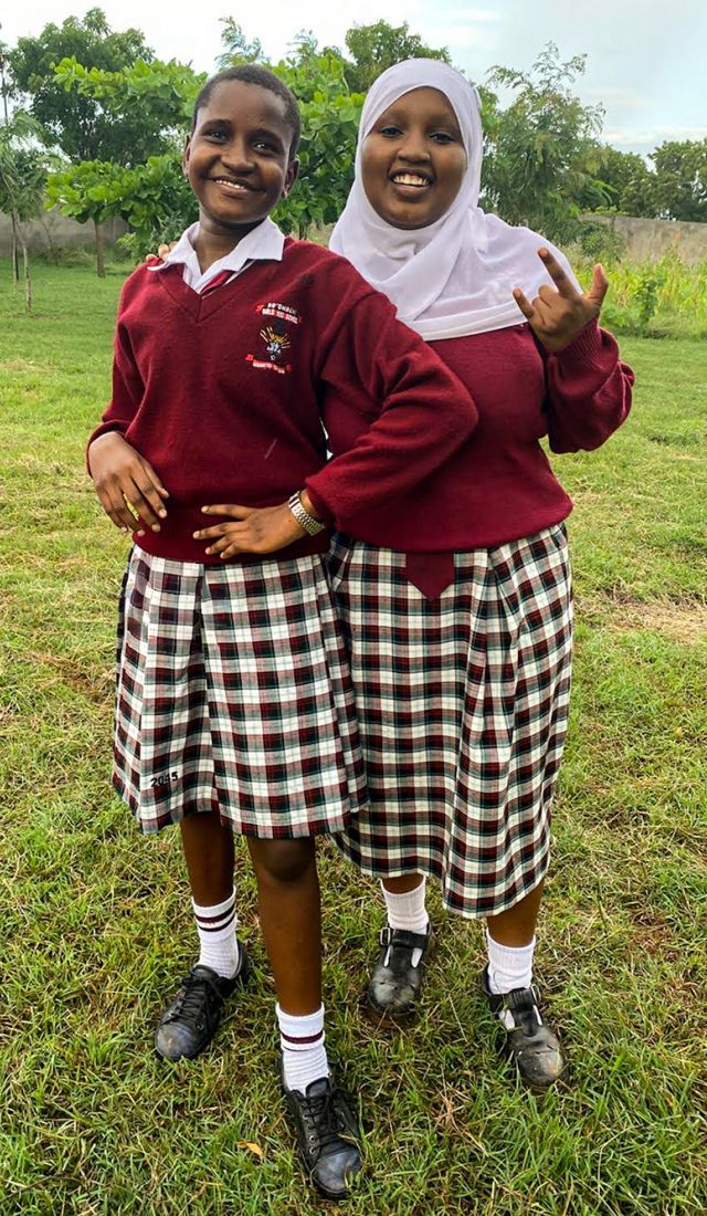 two school girls pose for camera