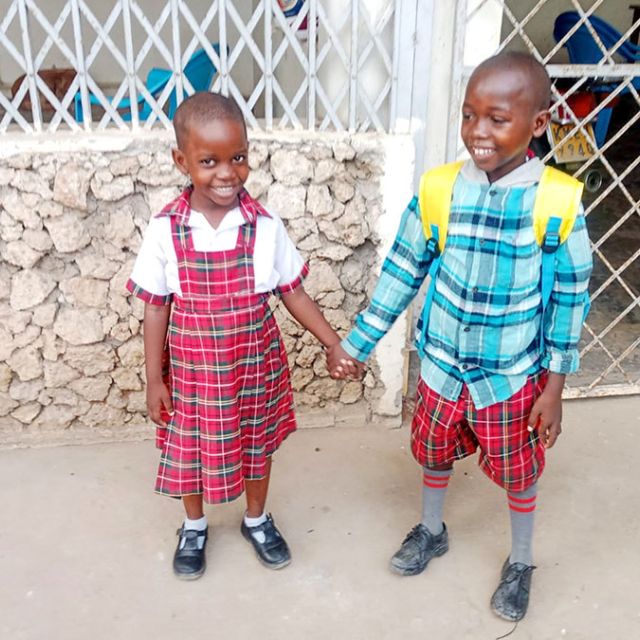 kids hold hands on way to school
