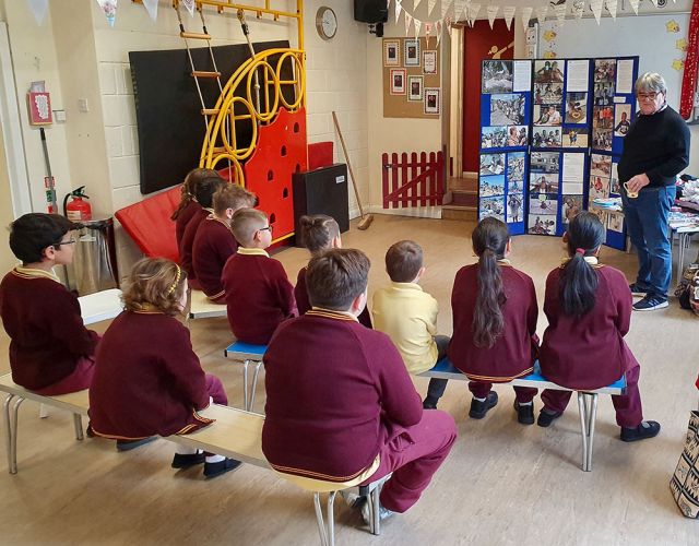 children in school watch presentation