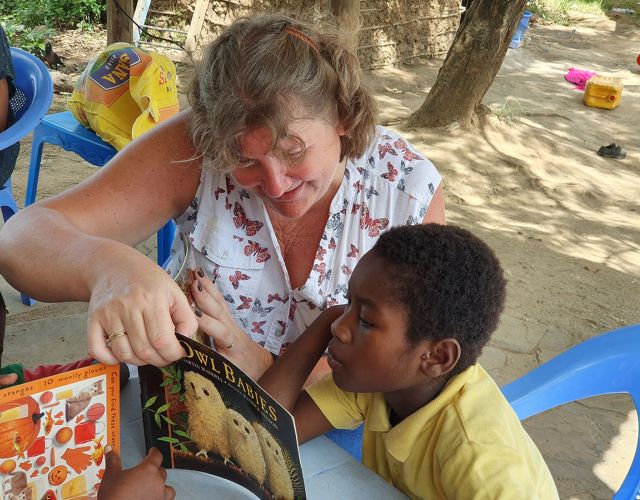 volunteer with child in Africa