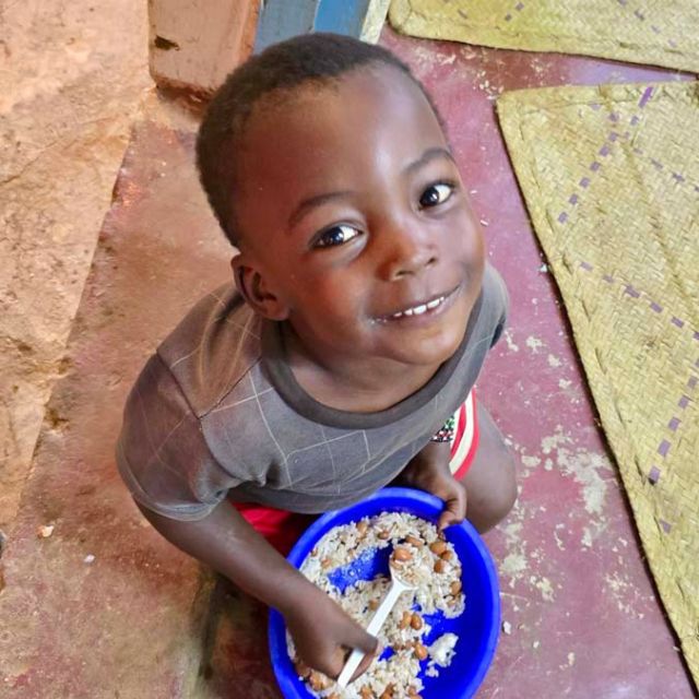 young child with rice meal